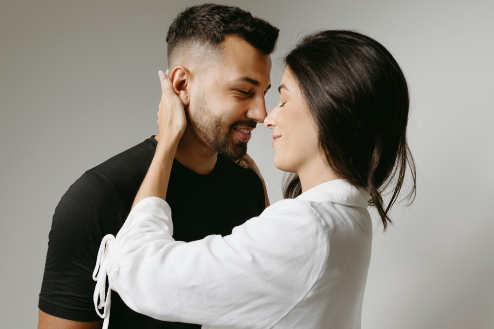 A couple smiling and gently embracing, showing warmth, trust, and emotional closeness often fostered through EFT therapy.