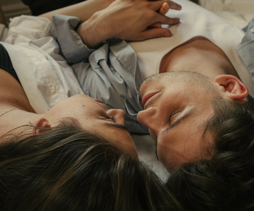 Intimate Utah couple enjoying time on top of a bed after couples therapy session.