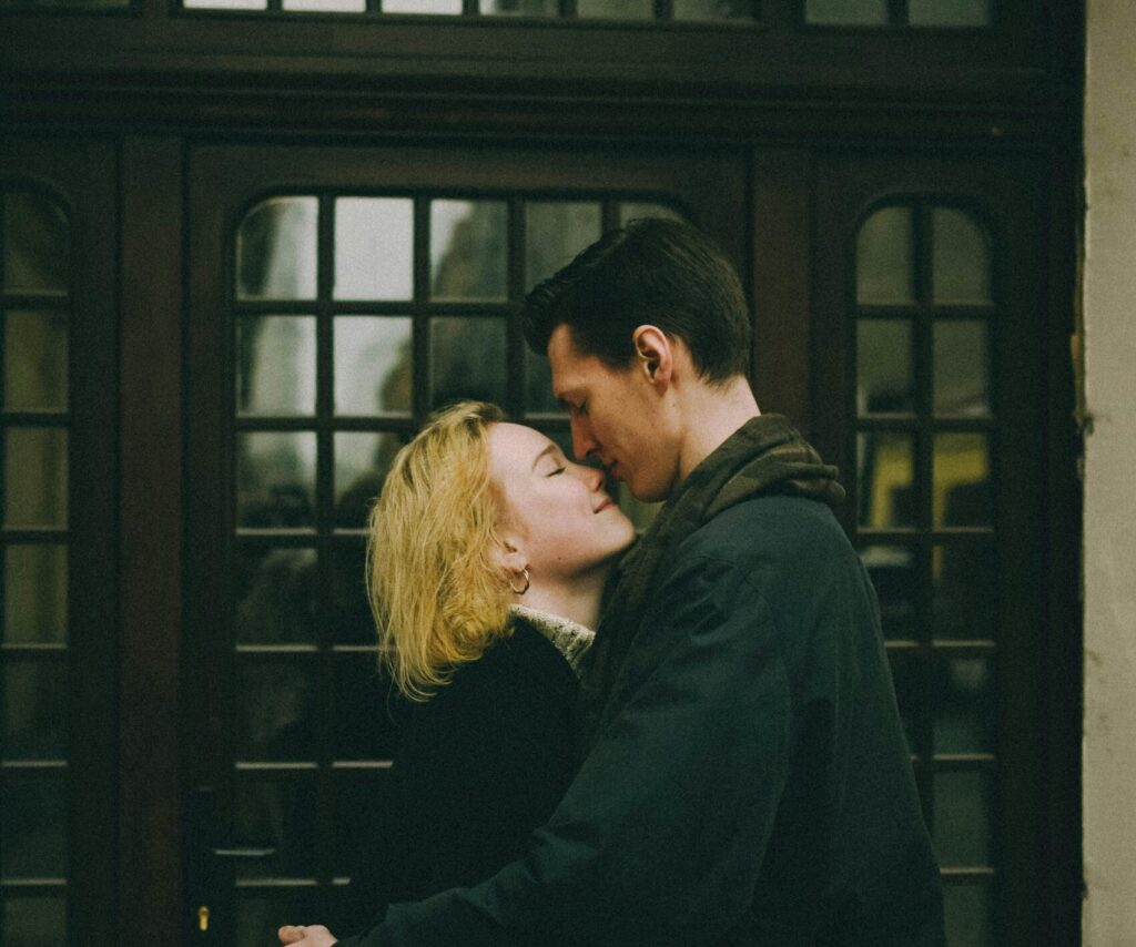 Utah couple share an intimate moment as they kiss outside a door before therapy session.