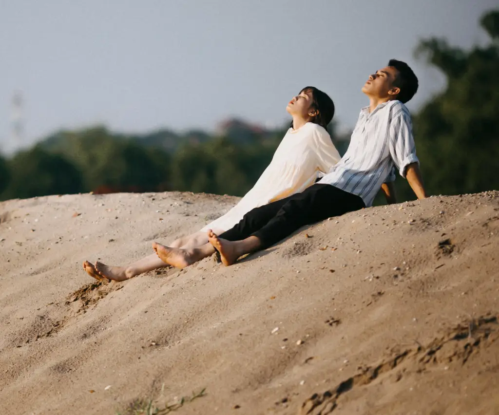 A couple enjoying time together in the sand.