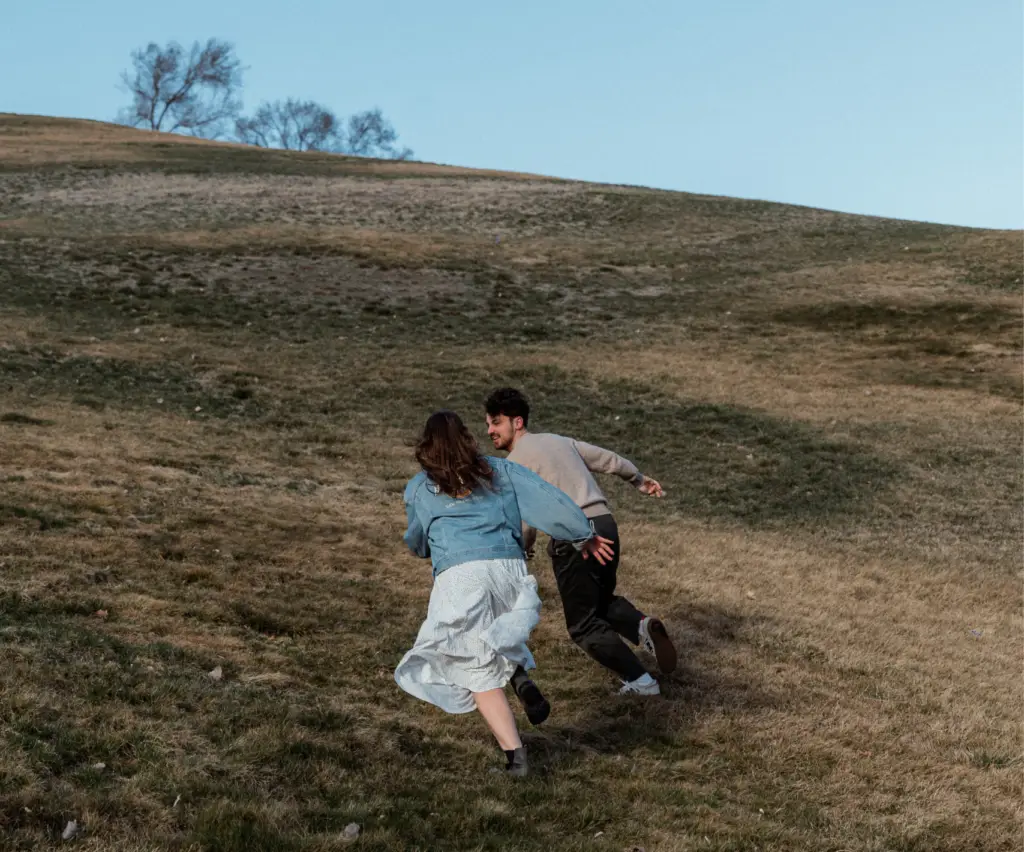 Couple after therapy session running lovingly up a Utah mountain.