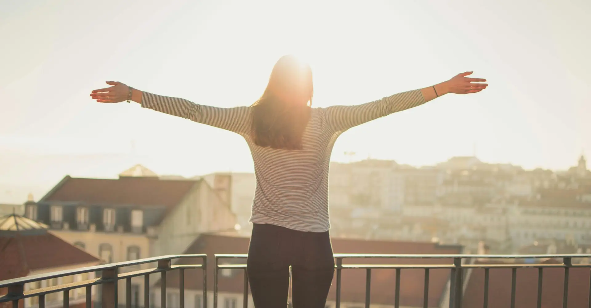 A hopeful woman with her arms out.