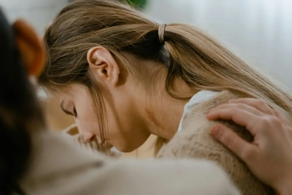 Person being comforted in a therapy session.