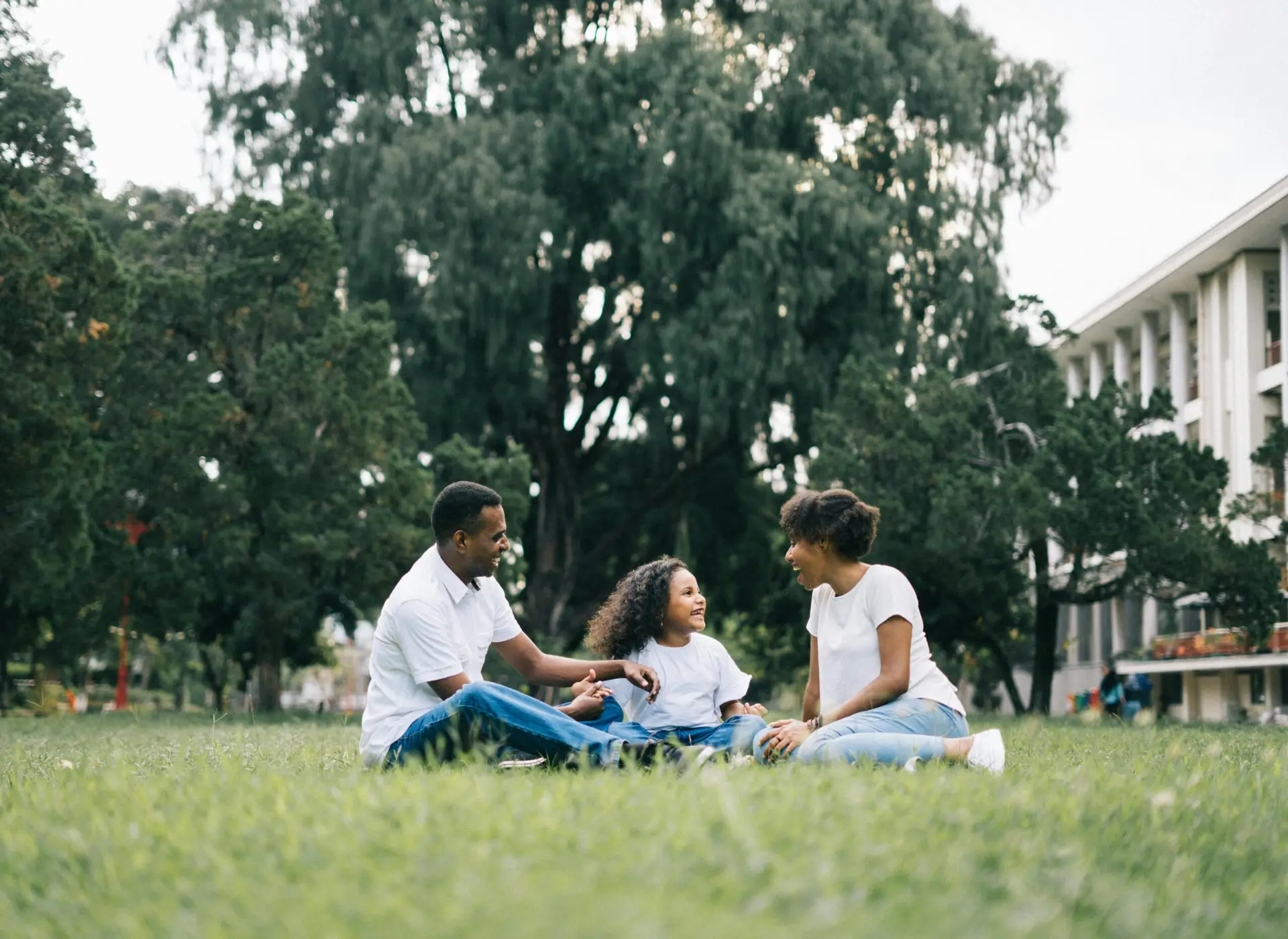 Happy family therapy and counseling session on a patch of Utah grass.