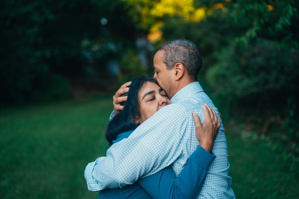 A woman gently embracing her partner, showing emotional comfort and acceptance.