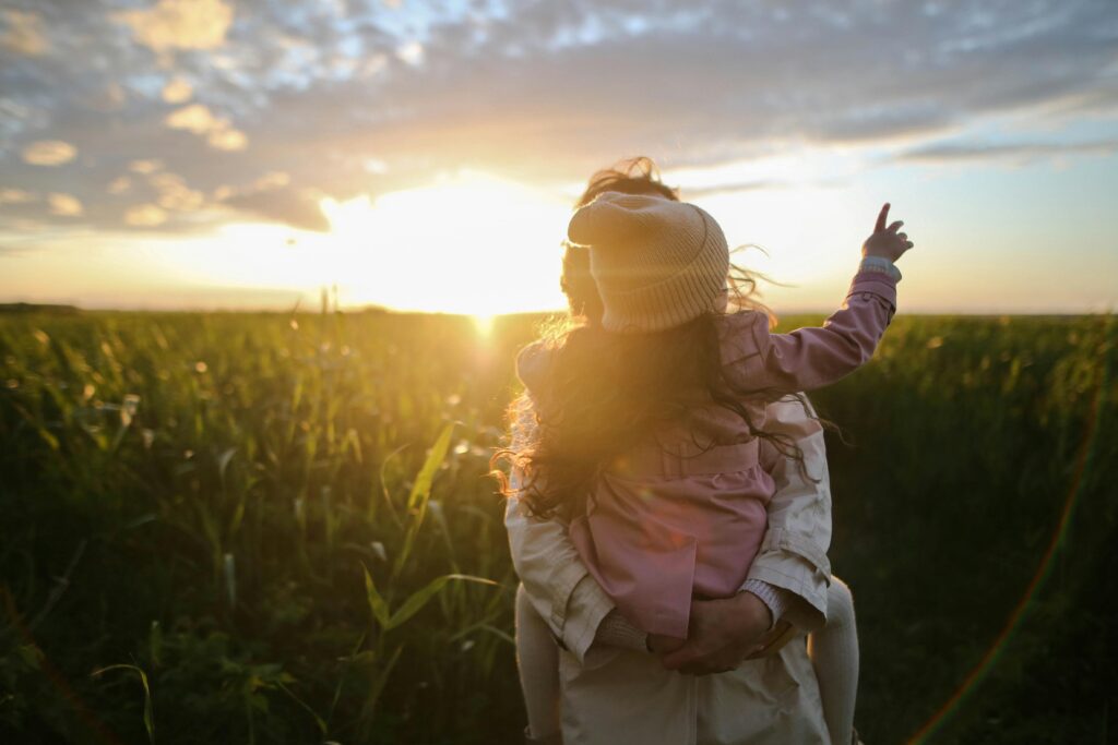 Happy family looking off into the sunset.